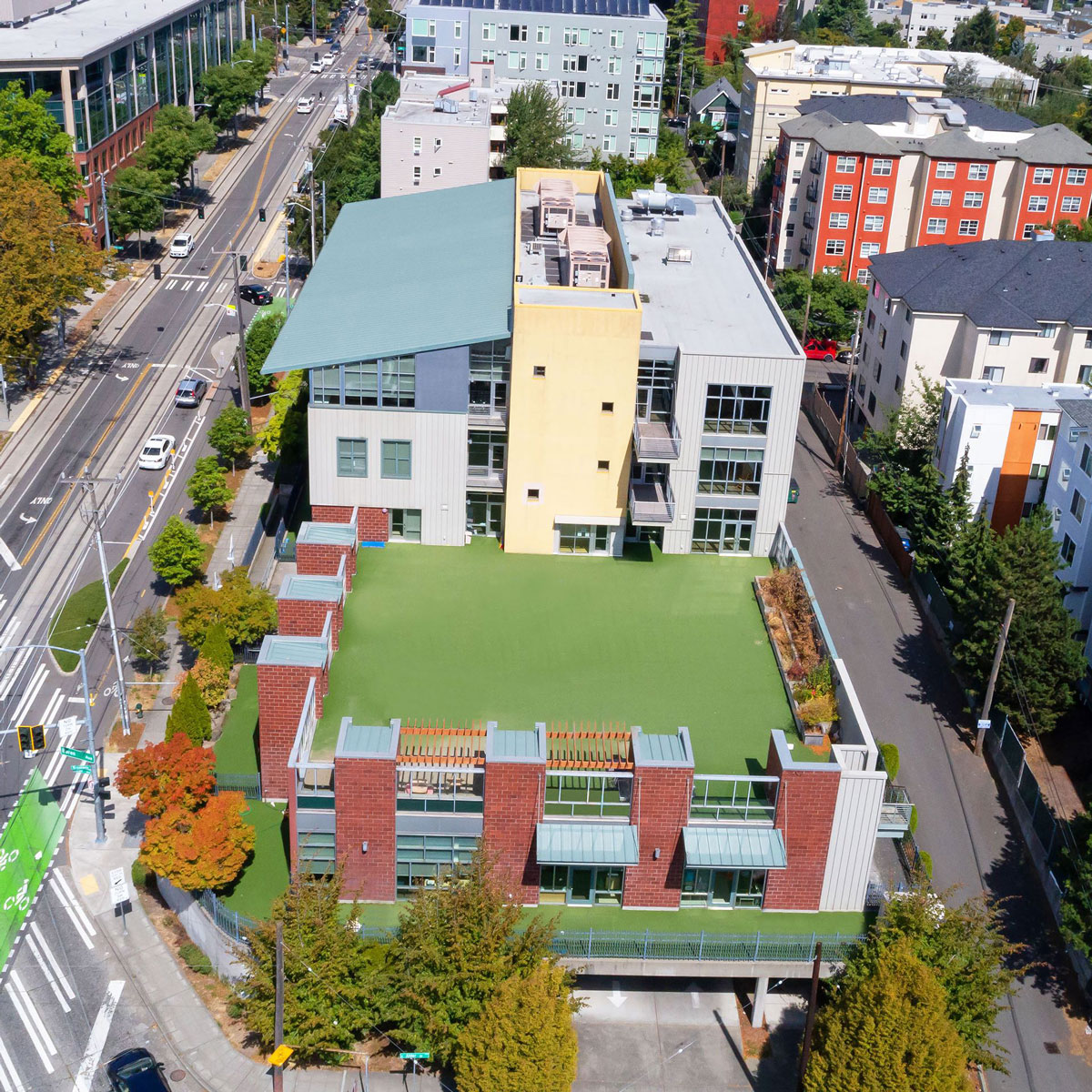 Cascade Public Media&#039;s new building, a large multistory building at a busy intersection, as seen from above